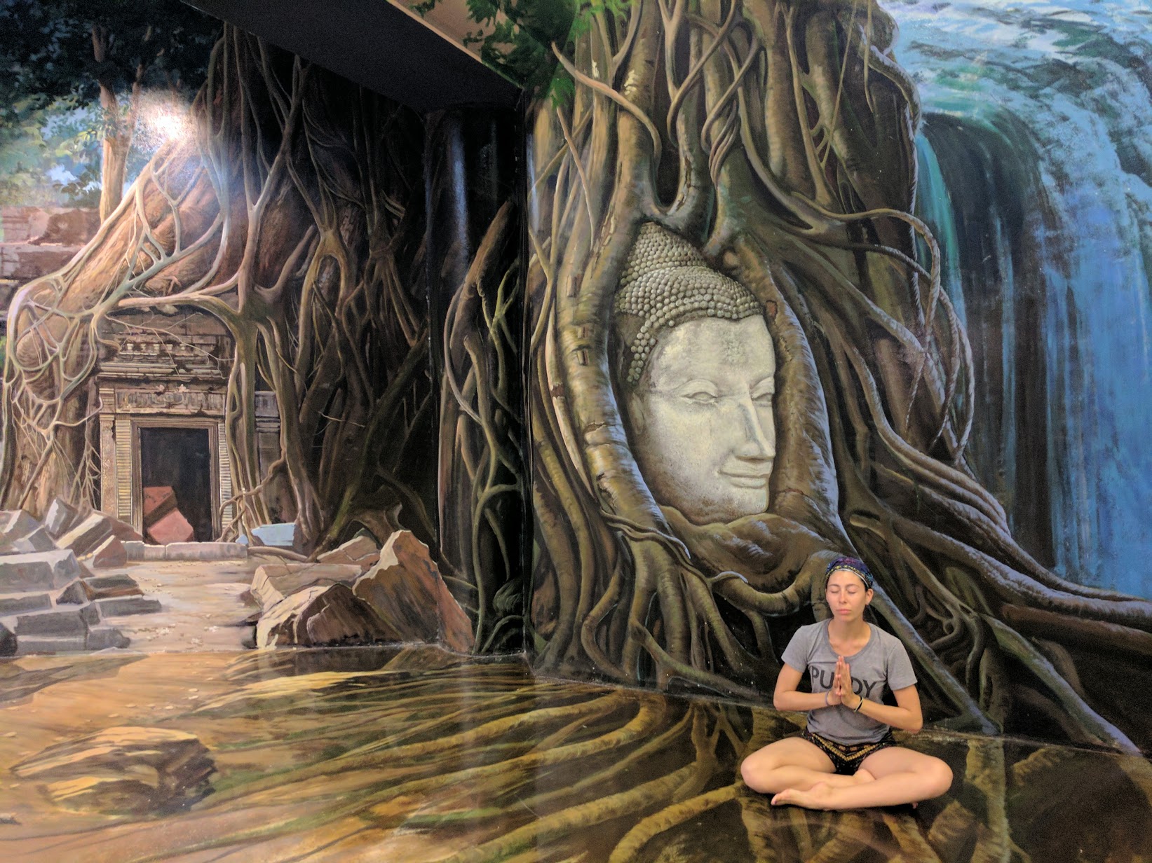 Yoga with Jules Forrister : Sitting against mural in Thailand's Museum of Illusions